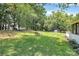 Expansive backyard with mature trees and an outside seating area, great for relaxation at 1011 Bydeford Ct, Matthews, NC 28105