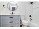 Modern bathroom with sleek vanity, round mirror, and tiled shower at 1011 Bydeford Ct, Matthews, NC 28105