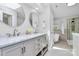 This bathroom features dual sinks, a soaking tub, and a separate glass-enclosed shower for a spa-like experience at 1011 Bydeford Ct, Matthews, NC 28105