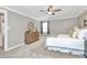 Cozy bedroom featuring neutral colors, a ceiling fan, and great natural light for a relaxing space at 1011 Bydeford Ct, Matthews, NC 28105