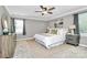 The spacious bedroom showcases comfortable furniture, soft carpet, and great natural light at 1011 Bydeford Ct, Matthews, NC 28105