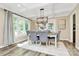 Elegant dining room with coffered ceiling, modern chandelier, and large windows at 1011 Bydeford Ct, Matthews, NC 28105