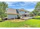 Expansive home exterior featuring a screened porch and well-maintained yard at 1011 Bydeford Ct, Matthews, NC 28105