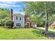 Two-story home with brick accents, a well-manicured lawn, and a side-entry garage at 1011 Bydeford Ct, Matthews, NC 28105