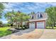 Two-story brick home with a well-manicured lawn and two-car garage at 1011 Bydeford Ct, Matthews, NC 28105