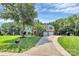 Two-story brick home with dormer windows, a long driveway, and landscaped yard at 1011 Bydeford Ct, Matthews, NC 28105