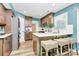 Modern kitchen with stainless steel appliances, brown cabinets, and counter seating at 1011 Bydeford Ct, Matthews, NC 28105