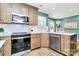 Well-lit kitchen featuring stainless steel appliances and natural wood flooring at 1011 Bydeford Ct, Matthews, NC 28105