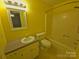 Bright yellow bathroom featuring a vanity, mirror, and shower-tub combination at 109 Phil Ct, Fort Mill, SC 29715