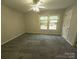 Large carpeted bedroom featuring a ceiling fan and window overlooking the outdoors at 109 Phil Ct, Fort Mill, SC 29715