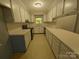 Functional kitchen with white cabinetry, laminate countertops, and a window above the sink at 109 Phil Ct, Fort Mill, SC 29715