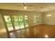 Bright living room featuring hardwood floors, ceiling fan, and sliding glass doors to the backyard at 109 Phil Ct, Fort Mill, SC 29715