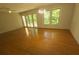 Spacious living room with hardwood floors, a ceiling fan, and natural light from the windows at 109 Phil Ct, Fort Mill, SC 29715