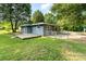 Fenced backyard of home with a large grassy area, surrounded by mature trees at 112 Lineberger St, Stanley, NC 28164