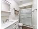 Modern bathroom with white vanity, updated fixtures, glass enclosed shower, and wood-look flooring at 112 Lineberger St, Stanley, NC 28164