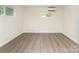 This bedroom has two windows, wood-look floors, and a modern mini split AC unit at 112 Lineberger St, Stanley, NC 28164