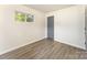 This bedroom has wood-look floors, a window for natural light, and neutral paint at 112 Lineberger St, Stanley, NC 28164