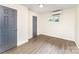 This bedroom has two doors, wood-look floors, and modern mini split AC unit at 112 Lineberger St, Stanley, NC 28164