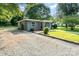 Well-maintained home features a gravel driveway, manicured lawn and a charming exterior at 112 Lineberger St, Stanley, NC 28164