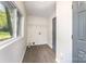 Bright laundry room with wood-look floors, window, shelving, and washer/dryer hookups at 112 Lineberger St, Stanley, NC 28164