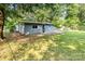 Charming single-story home featuring a fenced yard, stone patio, and mature trees offering privacy and shade at 112 Lineberger St, Stanley, NC 28164