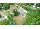 Aerial view of charming home with backyard pool, mature trees, and detached garage at 115 Turner St, Lincolnton, NC 28092