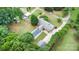 Aerial view showcasing the home, pool, manicured lawn, lush trees and detached garage at 115 Turner St, Lincolnton, NC 28092