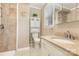 Well-lit bathroom has a shower, toilet, linen cabinet, and granite vanity top at 115 Turner St, Lincolnton, NC 28092