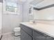 Bathroom with a vanity, mirror, and toilet at 115 Turner St, Lincolnton, NC 28092