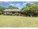 Charming brick ranch home featuring a well-manicured lawn and mature trees for added privacy at 115 Turner St, Lincolnton, NC 28092