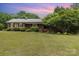 Charming brick ranch home featuring a well-manicured lawn and mature trees for added privacy at 115 Turner St, Lincolnton, NC 28092