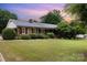 Charming brick home with manicured front lawn, mature landscaping and beautiful greenery at 115 Turner St, Lincolnton, NC 28092