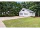 Detached two-car garage with white exterior surrounded by lush landscaping at 115 Turner St, Lincolnton, NC 28092