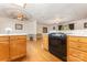 A black oven accents the wooden cabinets in this kitchen at 115 Turner St, Lincolnton, NC 28092