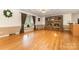 Living room with a cozy brick fireplace, hardwood floors, and lots of natural light from large window at 115 Turner St, Lincolnton, NC 28092