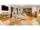 Staged living room featuring a cozy brick fireplace, hardwood floors, and lots of natural light at 115 Turner St, Lincolnton, NC 28092
