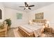 Staged main bedroom featuring a ceiling fan, a window, and a floral painting at 115 Turner St, Lincolnton, NC 28092