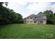Expansive backyard featuring a well-manicured lawn and a patio, perfect for outdoor entertaining at 11841 Churchfield Ln, Charlotte, NC 28277