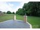 Large backyard with mature trees and patio area at 11841 Churchfield Ln, Charlotte, NC 28277