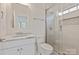 Bathroom featuring a glass enclosed shower, granite counter, and modern fixtures at 11841 Churchfield Ln, Charlotte, NC 28277