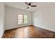 Bedroom with hardwood floors, natural light and a ceiling fan at 11841 Churchfield Ln, Charlotte, NC 28277