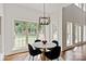Sun-filled breakfast nook with hardwood floors, and large windows overlooking the backyard at 11841 Churchfield Ln, Charlotte, NC 28277