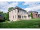 Large brick home with well maintained lawn and stone patio at 11841 Churchfield Ln, Charlotte, NC 28277