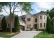 Beautiful two-story brick home with a well-manicured lawn and a two car garage at 11841 Churchfield Ln, Charlotte, NC 28277