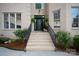 Inviting front entrance featuring stone steps and decorative landscaping with hanging ferns at 11841 Churchfield Ln, Charlotte, NC 28277