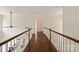 Second story hallway featuring hardwood floors and a view to the living room below at 11841 Churchfield Ln, Charlotte, NC 28277