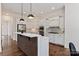 Bright modern kitchen with pendant lighting, custom cabinetry, and a kitchen island at 11841 Churchfield Ln, Charlotte, NC 28277