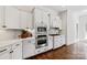 Well-appointed kitchen with white cabinets, stainless steel appliances, and mosaic backsplash at 11841 Churchfield Ln, Charlotte, NC 28277