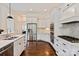 Bright kitchen boasts stainless steel appliances, white cabinets, and a mosaic backsplash at 11841 Churchfield Ln, Charlotte, NC 28277