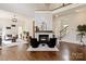 Open living room with soaring ceilings, a stone fireplace, and hardwood floors at 11841 Churchfield Ln, Charlotte, NC 28277